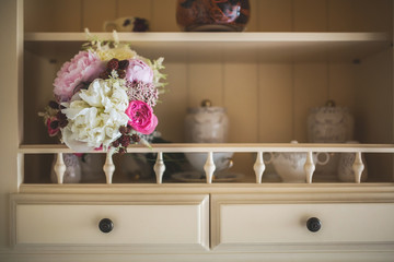 Bride bouquet in a kitchen shelf