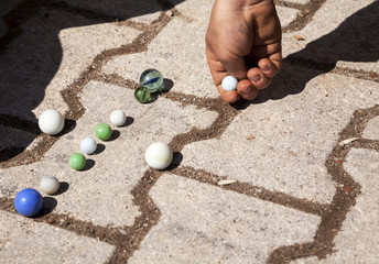 Marbles is an old outdoor game for children
