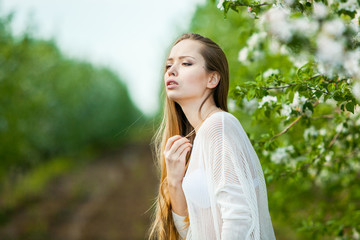 Spring portrait of a woman in a flowered garden