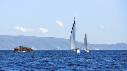 Obraz premium Sailing in the wind through the waves. Luxury yachts.