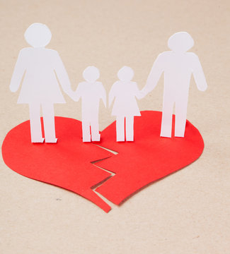 Divorce effect on kids concept with hands cutting paper  family