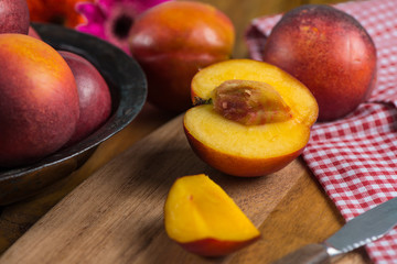 fresh nectarine peach cut on rustic board