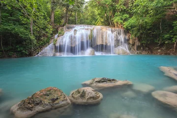 Foto op Plexiglas tropical waterfall in Deep forest © Noppasinw