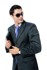 Businessman or hacker in sun glasses with laptop, isolated