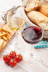 White and red wine glasses, cheese and bread