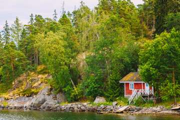 Red Finnish Wooden Bath Sauna Log Cabin On Island In Summer