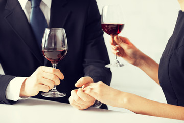 engaged couple with wine glasses