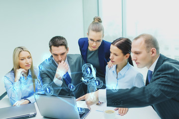 business team with laptop having discussion