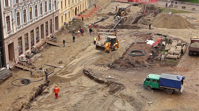 Aerial view of a construction site with workers and machinery