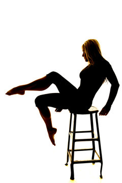 silhouette of a woman leg out on a chair