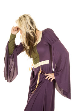 woman in a purple dress hand on head look down side