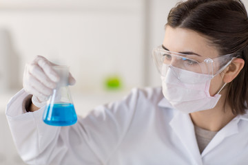 close up of scientist with flask making test