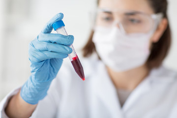 close up of scientist with tube making test in lab