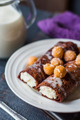 Fototapeta na wymiar chocolate pancakes with cottage cheese and condensed milk with b