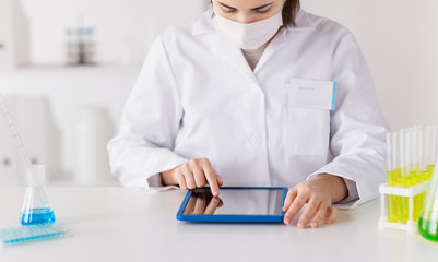 close up of scientist with tablet pc in laboratory