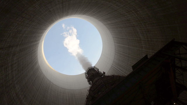 Steam rises from cooling tower
