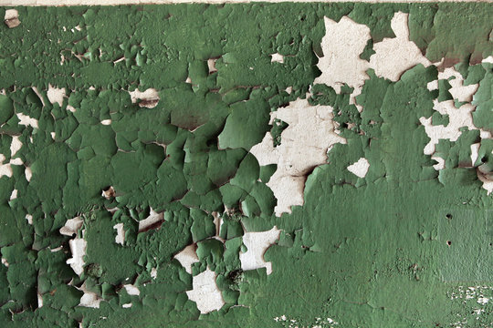 Abandoned wall coloured in green. Background texture.