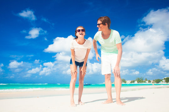 picture of happy couple in sunglasses on the beach