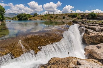 Fototapeta na wymiar Waterfall and river Cijevna in the rocks.