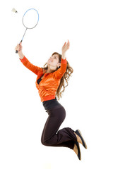 Woman jumping with racket for badminton catching shuttlecock