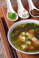 Japanese miso soup and ingredients close-up. Vertical