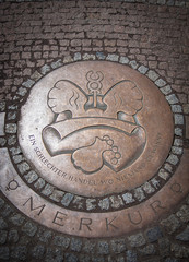 Round Iron hatch for sewer on cobblestone pavement © Artsaba Family