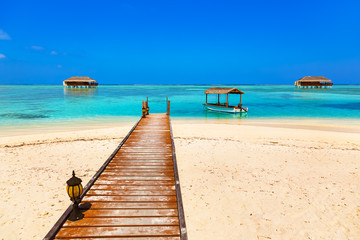 Boat and bungalow on Maldives island