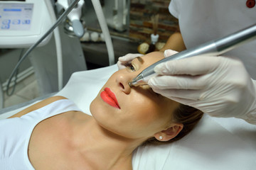 young woman during cosmetic body treatment
