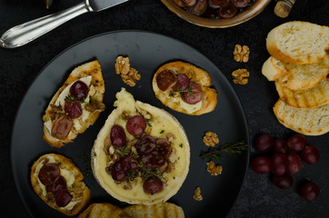 Brie cheese baked with nuts and grapes