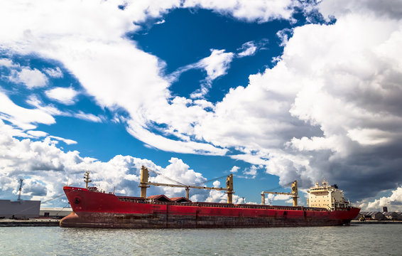 Red cargo container ship in port of Antwerpen