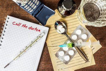 Call the doctor, a phone with a medical supplies on the table