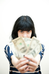 Brunette girl showing out of focus money in hands