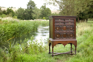 Chest of drawers on stand outdoors by a river
