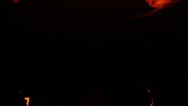 Fire show artist breathe fire in the dark