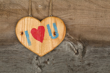 Love Valentines message wooden heart sign on rough grey backgrou