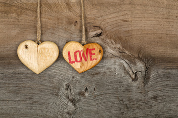 Love Valentines message two wooden hearts sign on rough grey bac