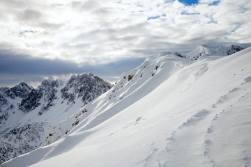 Fototapeta na wymiar Snow-capped mountains in winter day