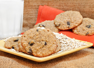 Oatmeal raisin cookies with milk.