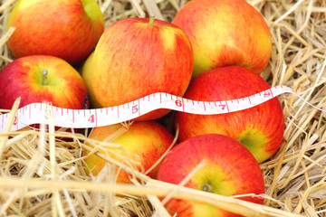 measure tape and red apple