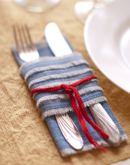 Elegant table dish with stylish setup for banquet. Dinner setup concept at jeans napkin