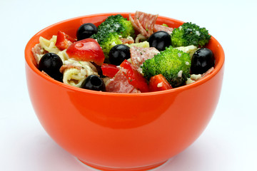 Pasta salad with olives, broccoli, salami and cheese.