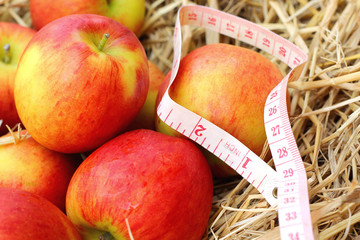 measure tape and red apple