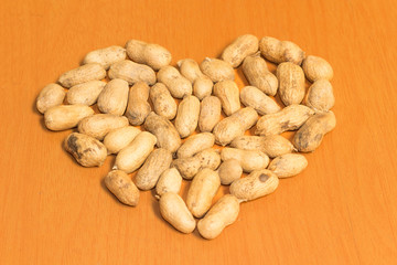 Heart from Dried peanuts on the brown table