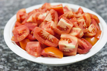 Red Tomato fresh slices in dish on table