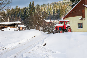 Naklejka premium farm tractor in snow