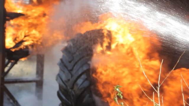 Fireman extinguishes the fire with a water jet