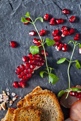 Sliced prosciutto with herbs and pomegranate seeds