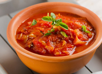 Homemade delicious minestrone soup in clay bowl