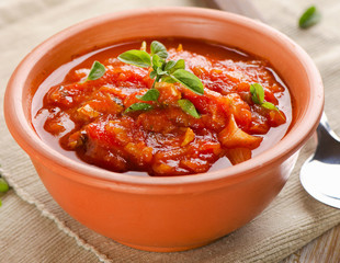 Homemade delicious minestrone soup in a clay bowl