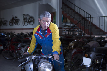 middle aged man placing a motorbike.